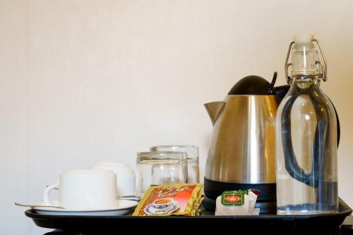 a tray with a coffee maker and a tea kettle at Sea View Villa Ukulhas in Ukulhas