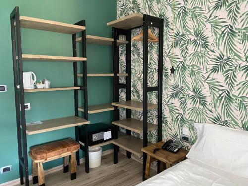 a bedroom with a bed and a book shelf at Hotel Villa Alberta in Nago-Torbole