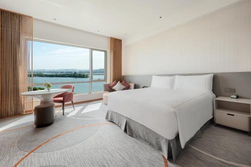 a bedroom with a large bed and a large window at InterContinental Suzhou Hotel by IHG in Suzhou