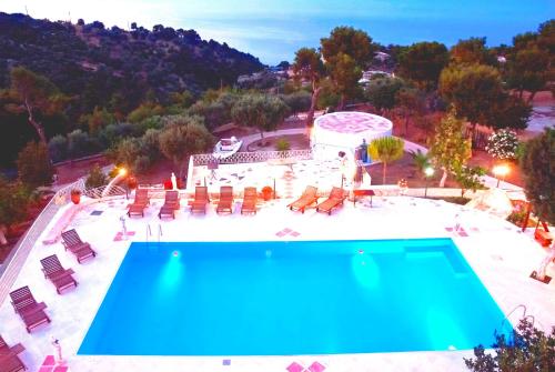 an overhead view of a swimming pool with chairs and a pool at Villa Agnanti Boutique in Grammatiko