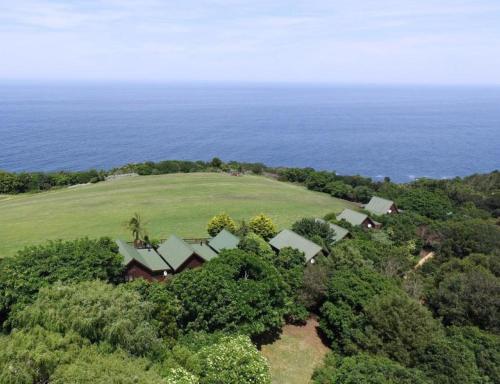 an aerial view of a house on a hill near the ocean at Misty Mountain Reserve in Stormsrivier