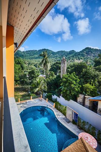 a swimming pool with a view of the mountains at Coco Palm Hotel Koh tao in Koh Tao