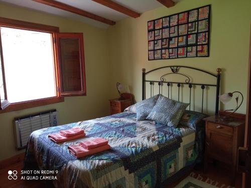 a bedroom with a bed with two pillows on it at Molino De Pradillo in Pradillo