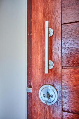 a wooden door with a metal handle on it at Coco Palm Hotel Koh tao in Koh Tao
