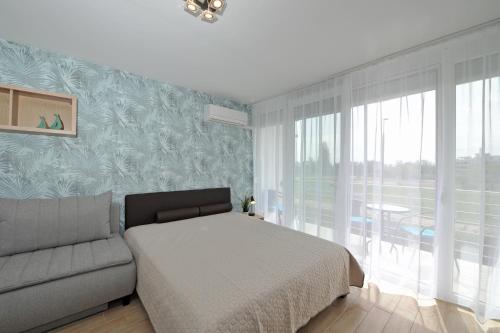 Posteľ alebo postele v izbe v ubytovaní Bella Flora Apartman