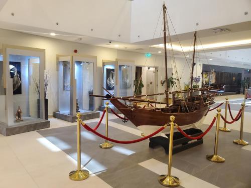a large boat on display in a museum at Al Kout Beach Hotel in Kuwait