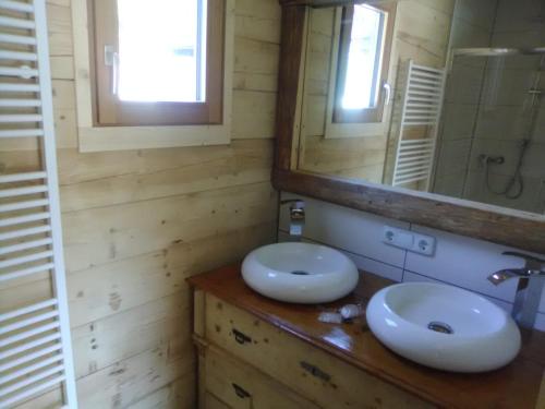 a bathroom with two sinks and a mirror at Troadkasten Seinerzeit in Aich