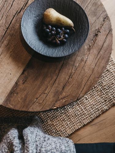 a bowl of fruit sitting on top of a wooden table at VAYA Zillertal inklusive Gästekarte Erste Ferienregion Zillertal in Aschau