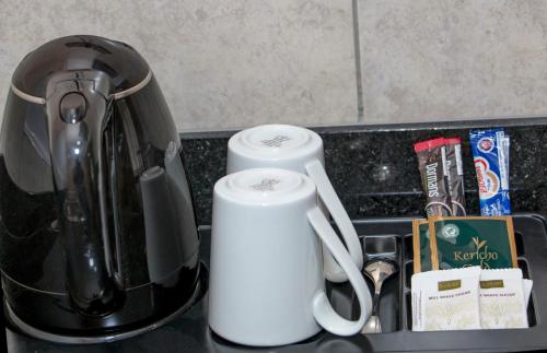 a counter top with two electric appliances on it at Hotel Comster Mtwapa in Mtwapa