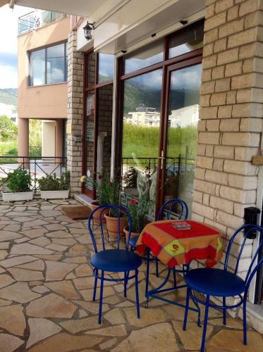 a patio with a table and chairs on a patio at Holiday Zigos in Igoumenitsa