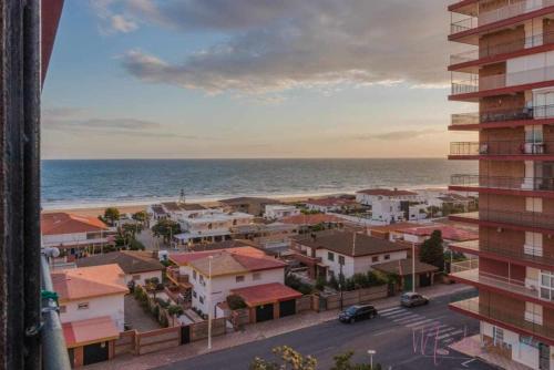 a view of a city and the ocean from a building at Tres dormitorios ,vistas al mar , junto a la playa in Punta Umbría