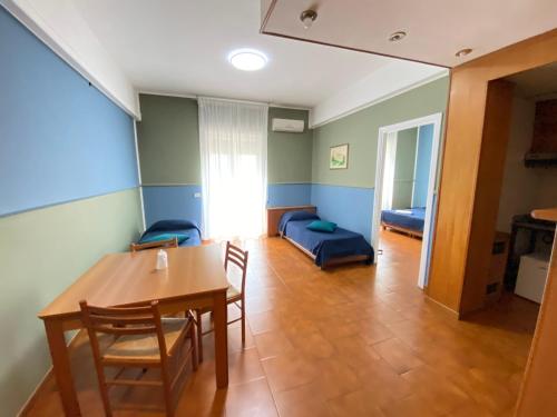 a living room with a table and chairs and a couch at Residence Hotel Valery in Monterotondo