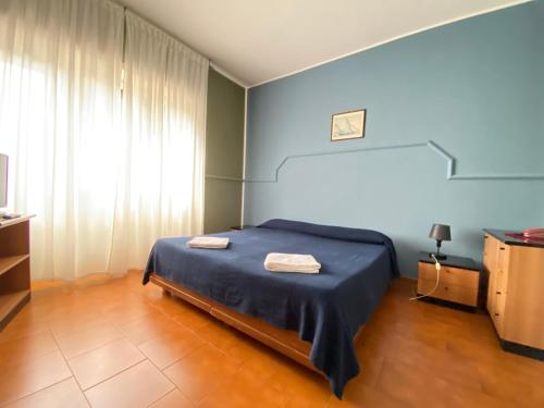 a bedroom with a bed with two towels on it at Residence Hotel Valery in Monterotondo