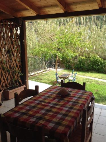 a screened in porch with a table and chairs at Holiday Zigos in Igoumenitsa