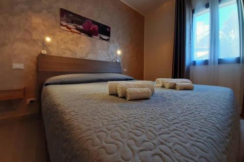 a bedroom with a large bed with two pillows on it at La Domus di Segesta in Calatafimi