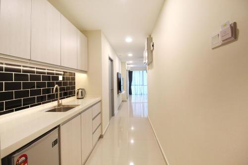 a kitchen with white cabinets and a sink at KL Eight Suites Newly completed 2021 in Kuala Lumpur