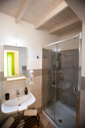 a bathroom with a sink and a shower at Quattro Incanti in Palermo