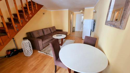 a living room with a white table and a couch at Becici Apart Budva in Budva