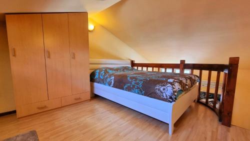 a bedroom with a bed and a wooden cabinet at Becici Apart Budva in Budva