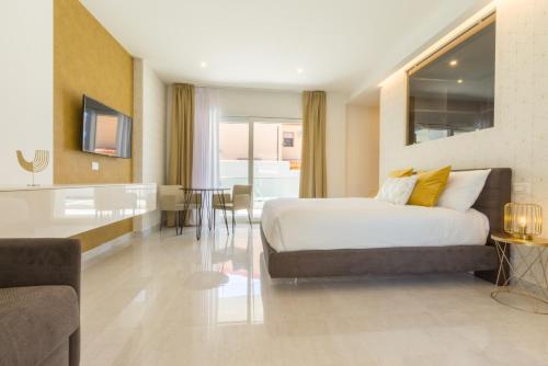 a bedroom with a bed and a living room at Residence Meridian Unità 2 in Villa San Pietro