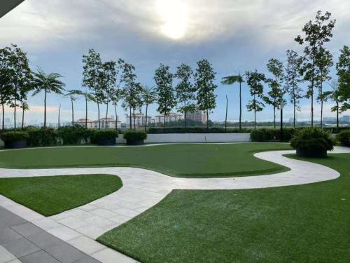 a golf course with a green yard and trees at YANGTZE HOME STAY 长江民宿 in Johor Bahru