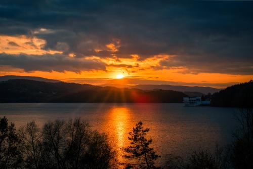 a sunset over a large body of water at Hotel Kasztelan in Dobczyce