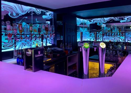 a bar with a bunch of bottles of alcohol at Hillgrove Guesthouse in Dingle