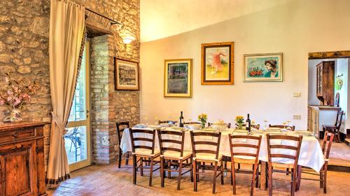 a dining room with a long table and chairs at Casale Cicognola 12, Emma Villas in Massa Martana