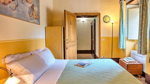 a bedroom with a large bed in a room at Casale Cicognola 12, Emma Villas in Massa Martana