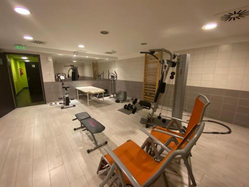 a room with a gym with chairs and a table at Boutique Hotel Sopianae in Pécs