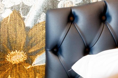 a close up of the back of a bed with a curtain at Deville & Spa in Costermano sul Garda