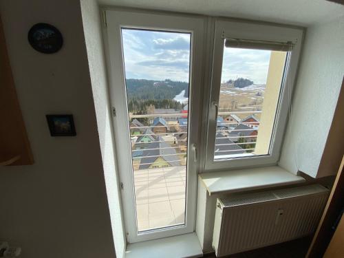 a window in a room with a view of a city at The Legits Apartments in Donovaly