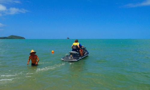 two people in the water on a jet ski in the ocean at South Pacific Bed & Breakfast in Clifton Beach