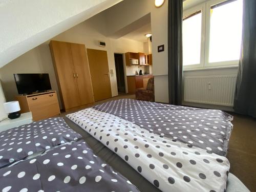 a bedroom with a large bed with polka dots at The Legits Apartments in Donovaly