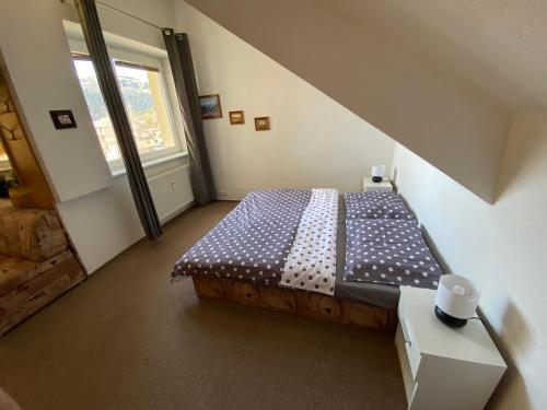 a bedroom with a bed in a room with a window at The Legits Apartments in Donovaly