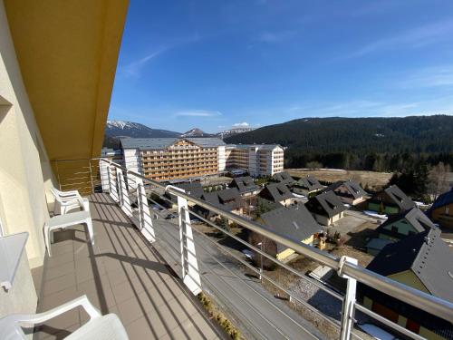 a balcony with a view of a city at The Legits Apartments in Donovaly