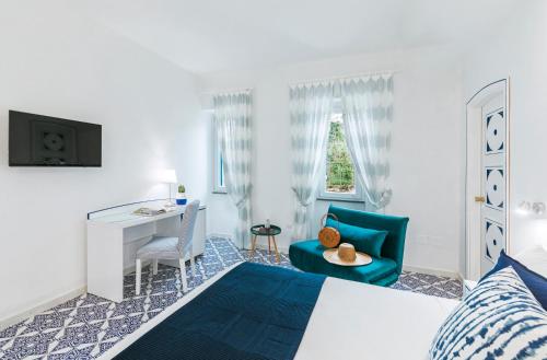 a bedroom with a bed and a desk and a chair at Villa Livia in Ischia