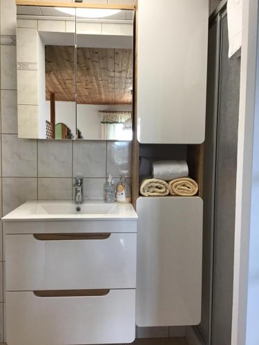 a white kitchen with a sink and a mirror at RUHEOASE LEX - vorm DerDieDasWohnen - der Bauernhof in Leutschach