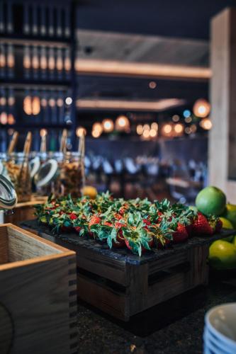 a bunch of strawberries on a cutting board on a counter at Hotel Gerl in Salzburg