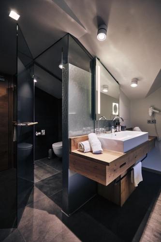a bathroom with a large sink and a shower at Hotel Gerl in Salzburg