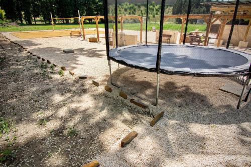 a playground with a trampoline on the ground at La Maison du Moulin de Tartay in Avignon