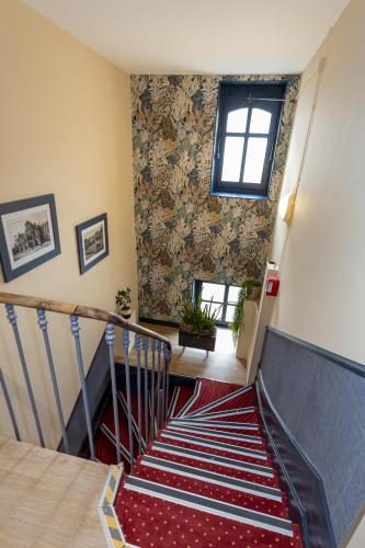 a staircase in a house with a window at Hotel Continental in Angers