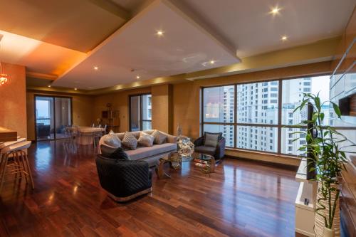 a living room with a couch and chairs at Elan suites 5 bedrooms penthouse with panoramic sea views in Dubai