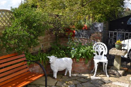 a statue of a sheep next to a bench at Mermaid Inn in Rye