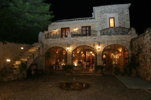 a large white building with lights on it at night at Meson Panza Verde in Antigua Guatemala