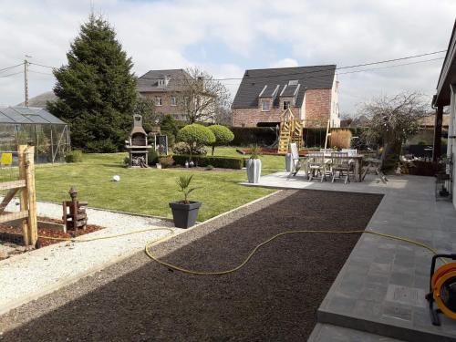 a house with a garden with a yellow hose at 't Hof van Cremers in Geraardsbergen
