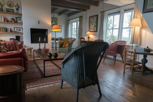 ein Wohnzimmer mit einem Sofa und einem Tisch in der Unterkunft Hello Zeeland - Vakantiehuis Klakbaan 4 in IJzendijke