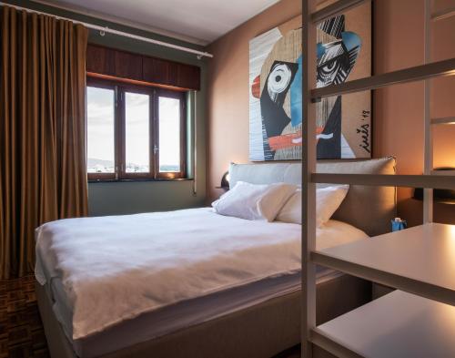 a bedroom with a bunk bed and a window at urban beach sixties in Portimão