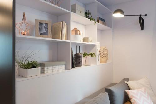 a living room with white shelves with potted plants at Bootsmann in Breiholz