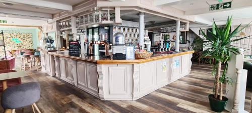 a bar in a restaurant with a counter at Beach Green Hotel in Lancing